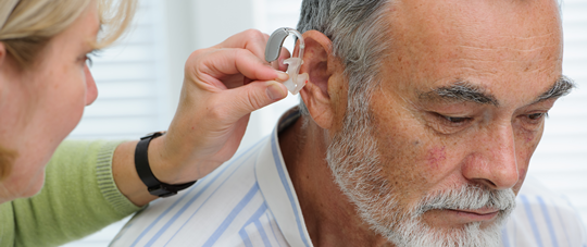 Patient Being Fitted with Hearing Aid Patient Being Fitted with Hearing Aid